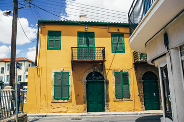 The old building. The shutters on the Windows. Beautiful building. northern Cyprus. Turkish Republic of Northern Cyprus. Yellow building with green Windows