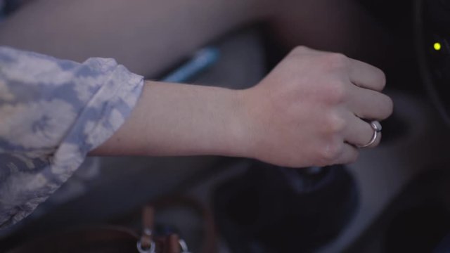 Closeup Of Young Woman's Hand Shifting Gears, Slow Motion 