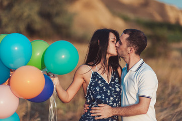 Couple in love for a walk in nature with baloons
