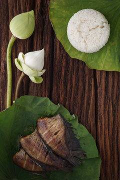thai food rice and dried salted damsel fish fried with flower lotus jasmine decoration on wooden background