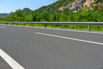 Empty asphalt road under blue sky.