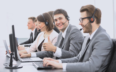 employee call center with headset showing thumb up