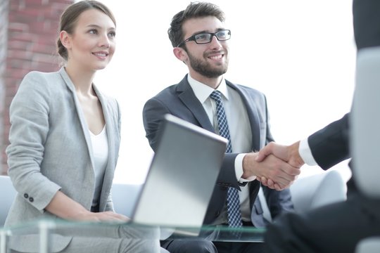 handshake business partners after discussing the contract