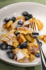  kaiserschmarrn with blueberries sprinkled with powdered sugar