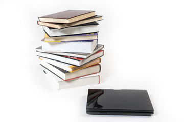Stack of book and laptop isolated on white