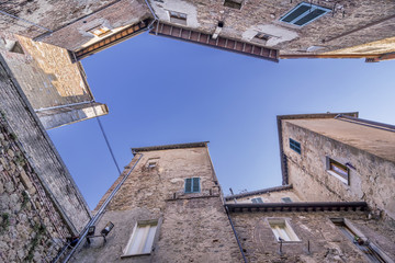 Fototapeta na wymiar Beautiful bottom view of the stone houses of the historic center of Chianciano Terme, Siena, Italy, against the blue sky