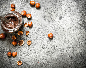 nut butter from hazelnuts and chocolate. On rustic background.