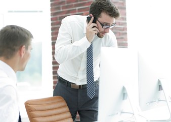 angry businessman talking on smartphone