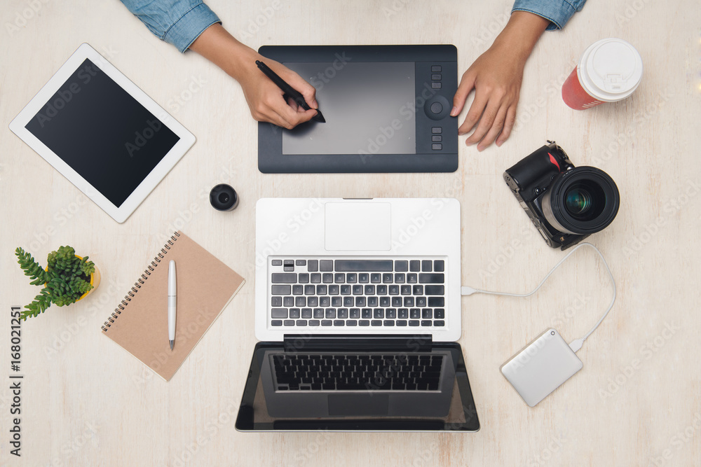 Poster graphic designer working with digital tablet at desk. top view.