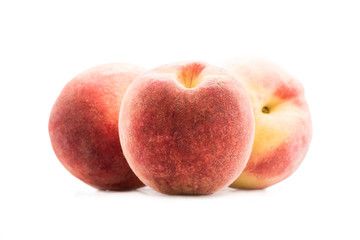 close up view of fresh and ripe peaches isolated on white