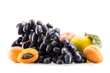 close up view of fresh grapes, apples and apricots isolated on white