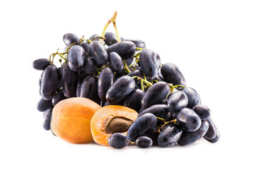 close up view of fresh ripe and sweet grapes and apricots isolated on white