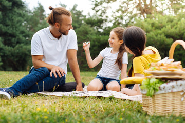 Adorable girl showing a puzzle to her father