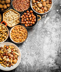 A lot of nuts in different bowls.