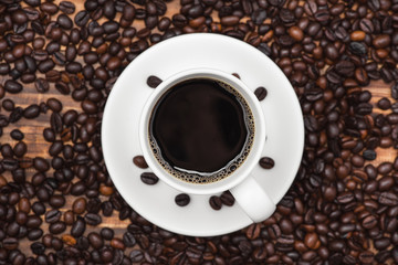 Cup of coffee espresso and beans on a rustic background