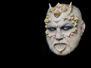 horror man or monster with thorns on face with makeup