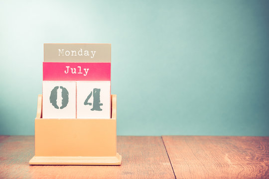 Fourth of July on retro wooden desk calendar. Date of USA Independence Day holiday. Vintage style filtered photo