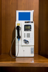 White vintage public pay phone