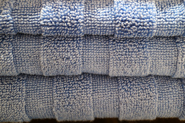 Closed up Texture of Neatly Folded Pale Blue Fluffy Bath Towels Stack, for Background or Banner 