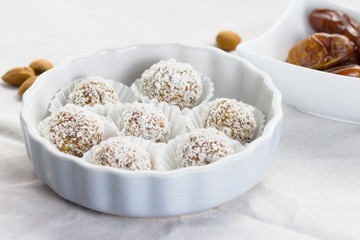 Date and almond pralines in ground coconut