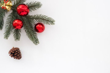 Christmas and New Year background -  fir tree and pine cone with decoration on white background with copy space. Creative Flat layout and top view composition.