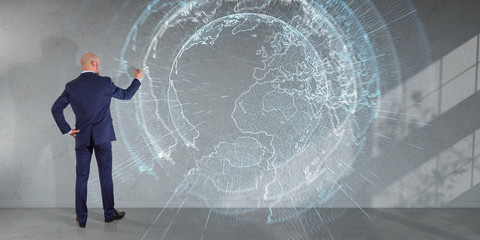 Businessman using digital planet earth interface on a wall 3D rendering