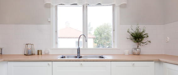 panorama of kitchen sink and kitchen counter top by the window in fancy kitchen