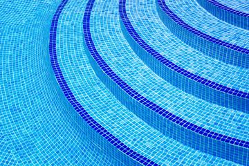 Blue steps stairway into swimming pool