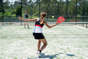 Two women playing padel outdoor
