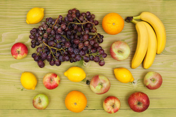 Close up of various fruits at rustic wooden background.
