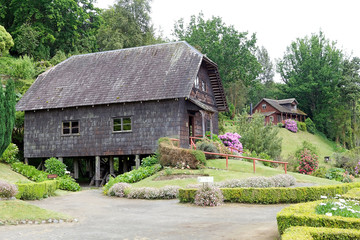 Fototapeta na wymiar Watermill and house at the German Museum at Frutillar, Chile