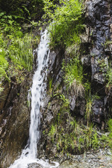 Small waterfall in rocky Fagaras mountains at Carpathians in Romania