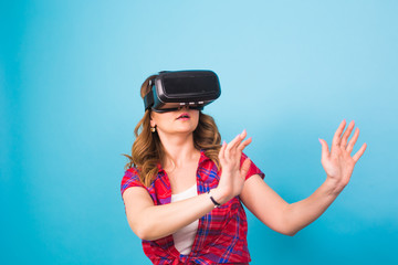 Happy young woman using a virtual reality headset.