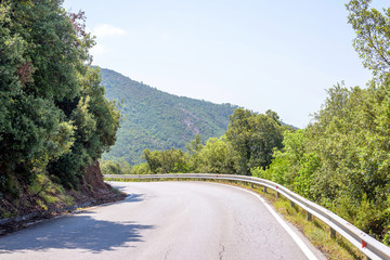 Daylight view to a road in mountains of Monterosso. Trees on background. Italy, Cinque Terre.