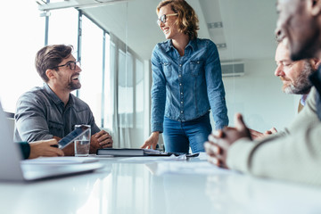 Young businesswoman talking with colleagues