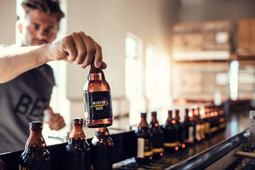 Young man examining the quality of beer