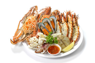 Grilled Mixed Seafood Contain Blue Crabs, Mussels, Big Prawns, Calamari Squids and Roasted Barracuda Fish Garlic with Spicy Chili Sauce and Lemon on Platter, Isolated on White Background with Shadow.