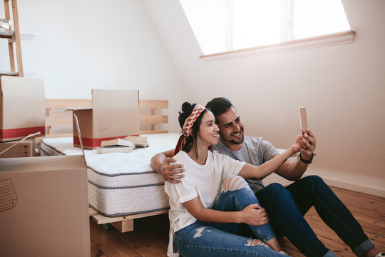Couple moving in new place and making a selfie