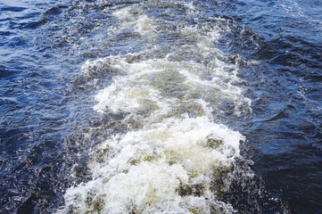 Wave from a boat on the water. Texture of water.