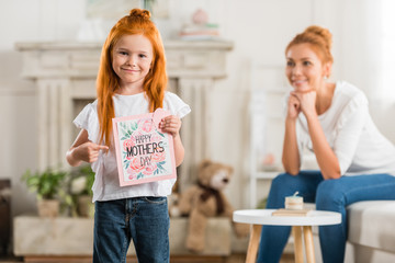 girl with happy mothers day postcard