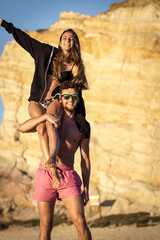 Female siting on male shoulders - friends