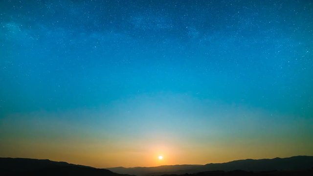 The picturesque sunset on the background of the mountain. time lapse
