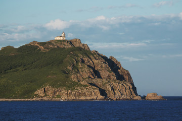Fototapeta na wymiar old lighthouse on a rocky promontory