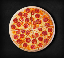 Pepperoni pizza on a black background. Visit my page. You will be able to find an image for every pizza sold in your cafe or restaurant