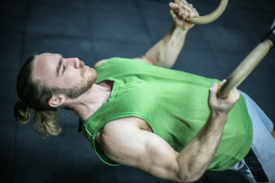 Attractive fit man working out at the gym. Fit and attractive man working out at a gym with dramatic lighting.