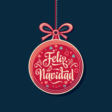 Feliz Navidad.  Red Christmas ball with good wishes in Spanish. 