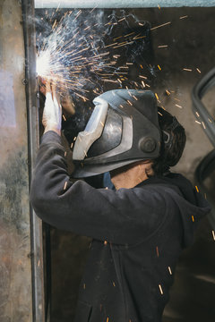 Blacksmith welding indoors