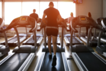 Row of treadmills in modern fitness center.