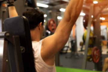 Blurred picture of exercising male in gym