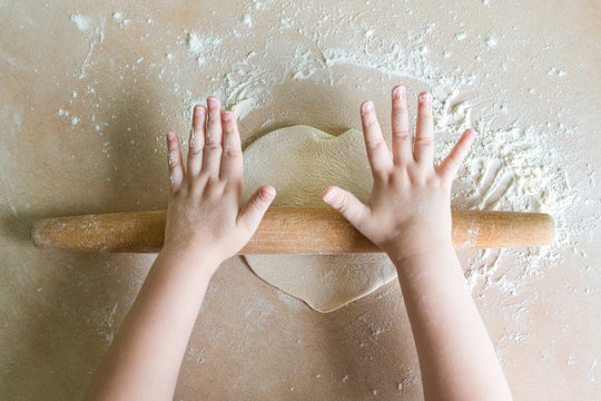 Children's hands rolled dough